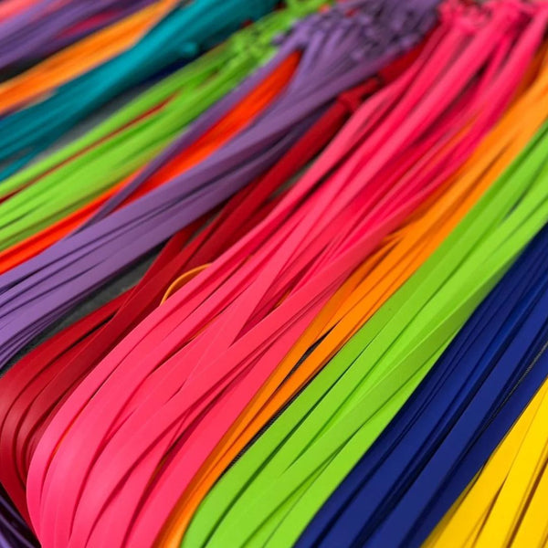 rainbow of biothane leashes laying together