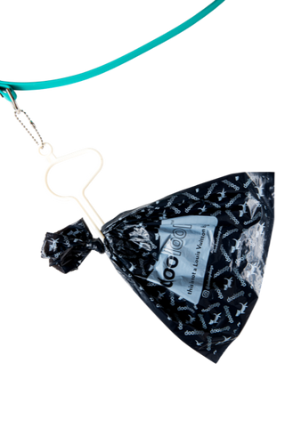 white dooloop with doo bag hanging from leash