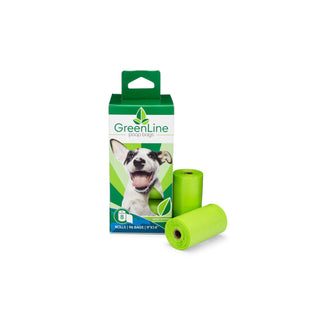 small green and white box from Greenline with white and black happy dog and two rolls of green poop bags next to the box