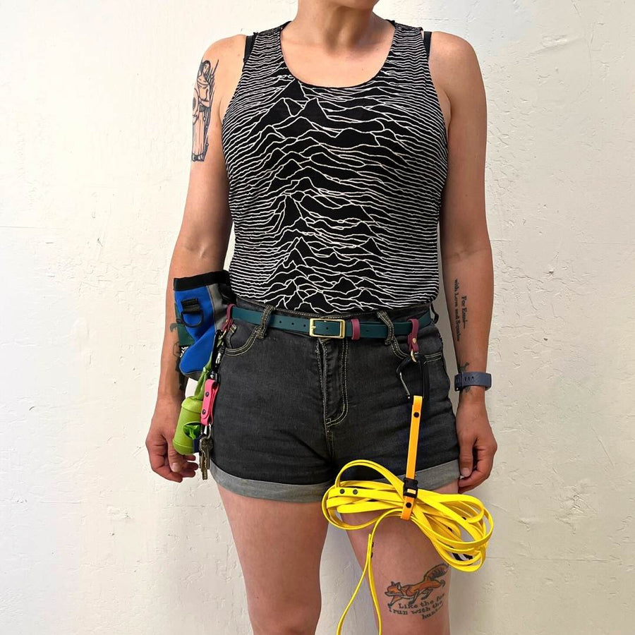 person wearing a biothane utility belt in forest green with other accessories attached