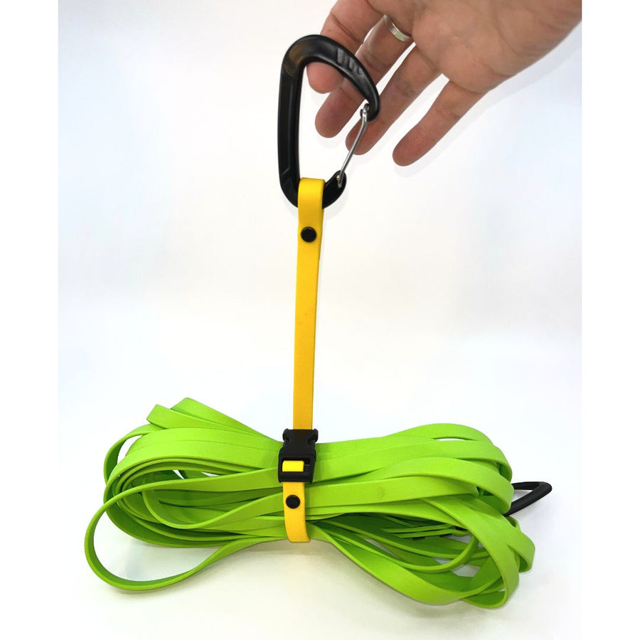persons hand holding the clip on the biothane quick release long line keeper