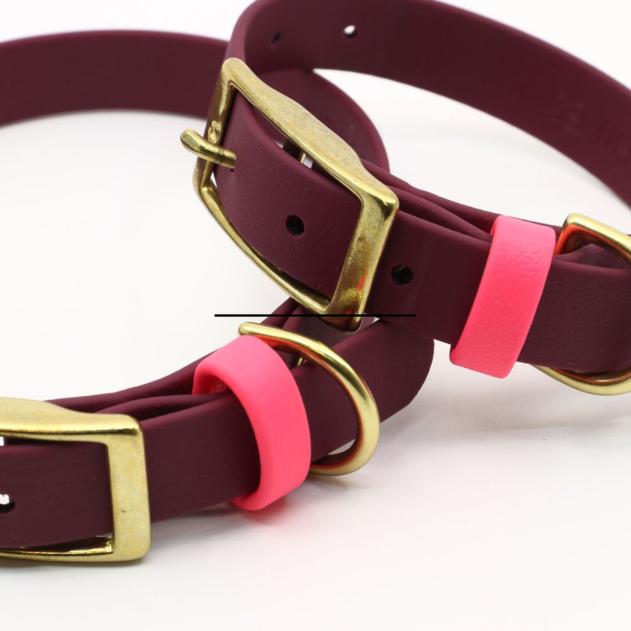 close up of plum biothane collar with flamingo accents and brass hardware
