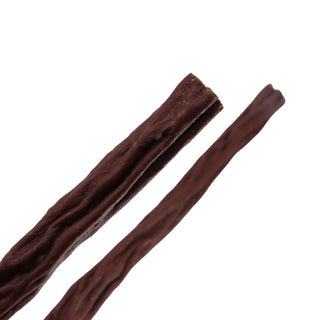 two pieces of happy howies woof stix dog treat on white background