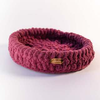 dark pinkhand crocheted pet bed from little noses boutique on a white background