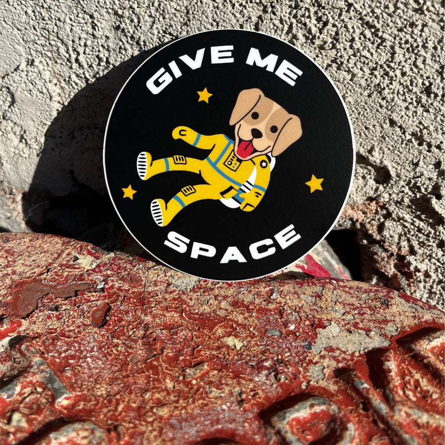 round black sticker with an astronaut dog saying Give Me Space