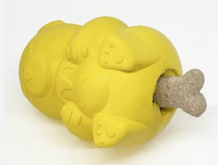 rubber honey bear dog treat dispenser on its side showing a treat going in