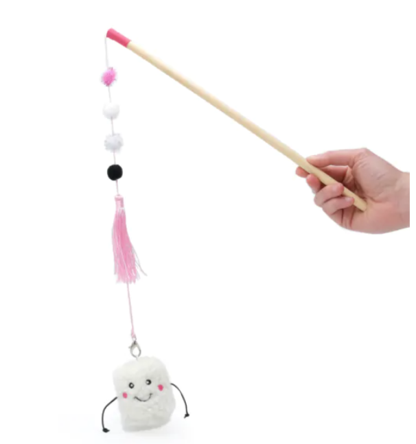 persons hand holding a stick with pink and white string and fuzzies  along the string handing down and a white marshmallow at the end