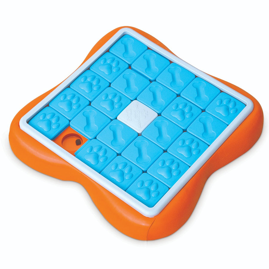 a plastic dog puzzle toy with sliding treat compartments that is orange, blue, and white