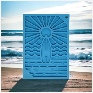 blue surf's up design on the emat dog entrichment lick mat with an ocean background