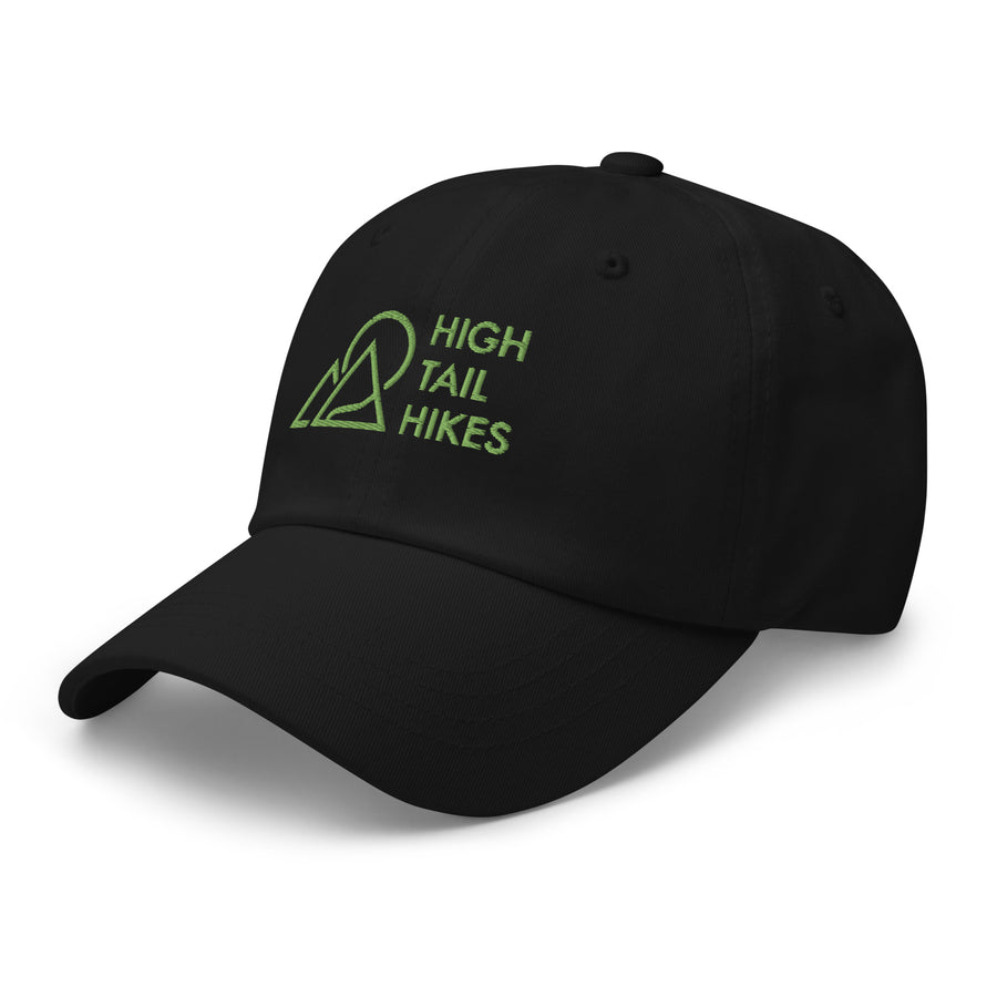 kinda side view from the front of black dad hat with green high tail hikes logo