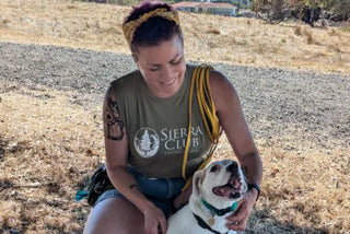 Cory Abshear wearing a Sierra Club shirt sitting outdoors with a dog.