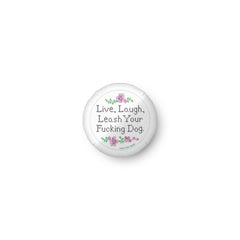 white round pillow that reads in cross stitch font "Live, Laugh, Leash Your F Dog