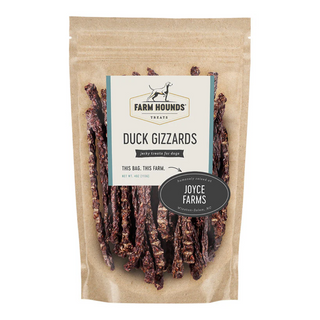 white background, tan package with jerky looking meat strips for dogs behind a clear cover, off white label that reads "Farm Hounds Treats, Duck Gizzards, Humanly raised by Joyce Farms"