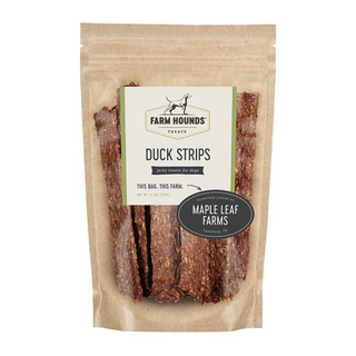 white background, tan package with jerky looking meat strips for dogs behind a clear cover, off white label that reads "Farm Hounds Treats, Duck Strips, Humanly raised by Maple Leaf Farms"