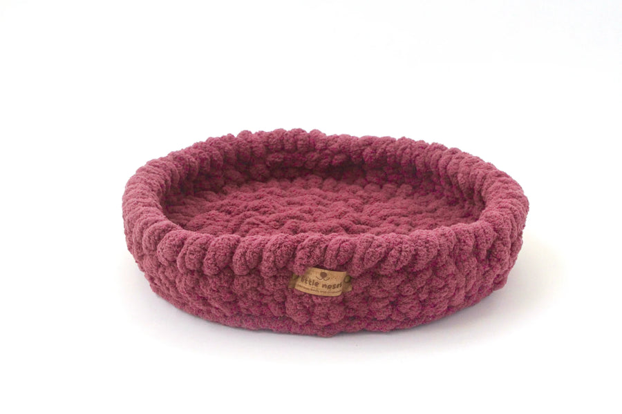 dark pinkhand crocheted pet bed from little noses boutique on a white background