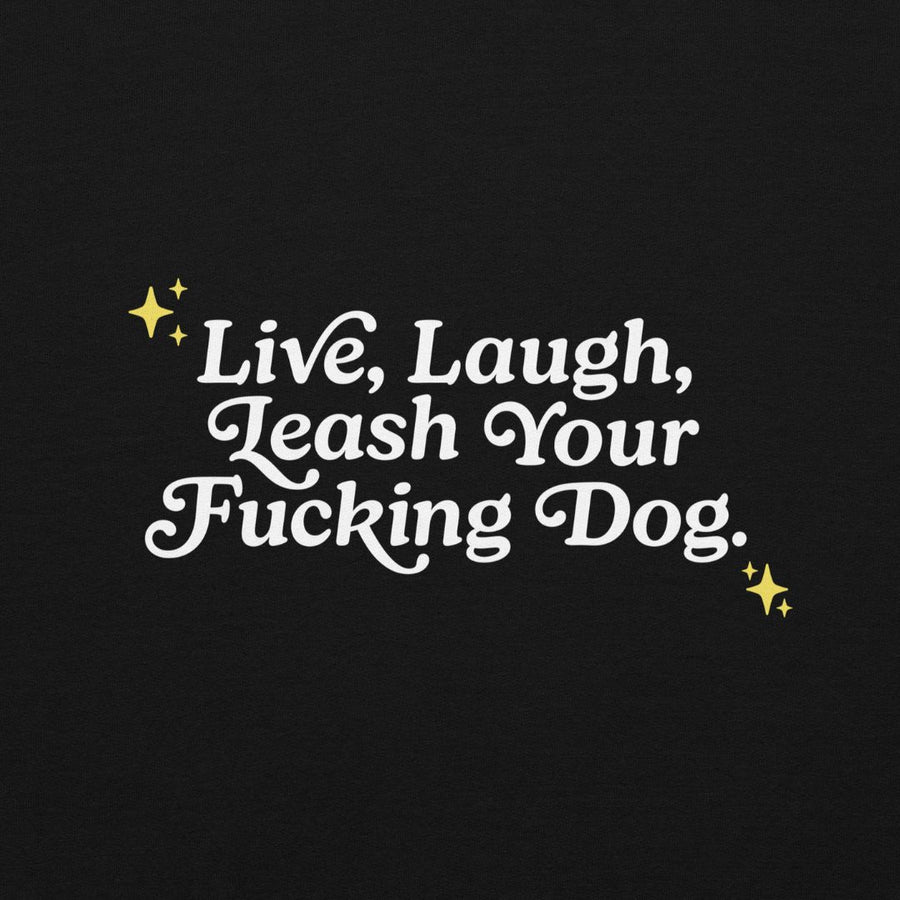 close up of back of black hoodie with white letters that read "Live, Laugh, Leash Your F Dog"
