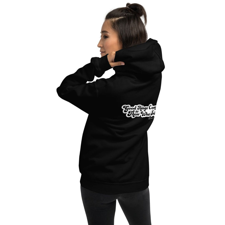 female lifting hood of a black hoodie sweatshirt, the back of it reads "Good Things Come to Those Who Sniff"
