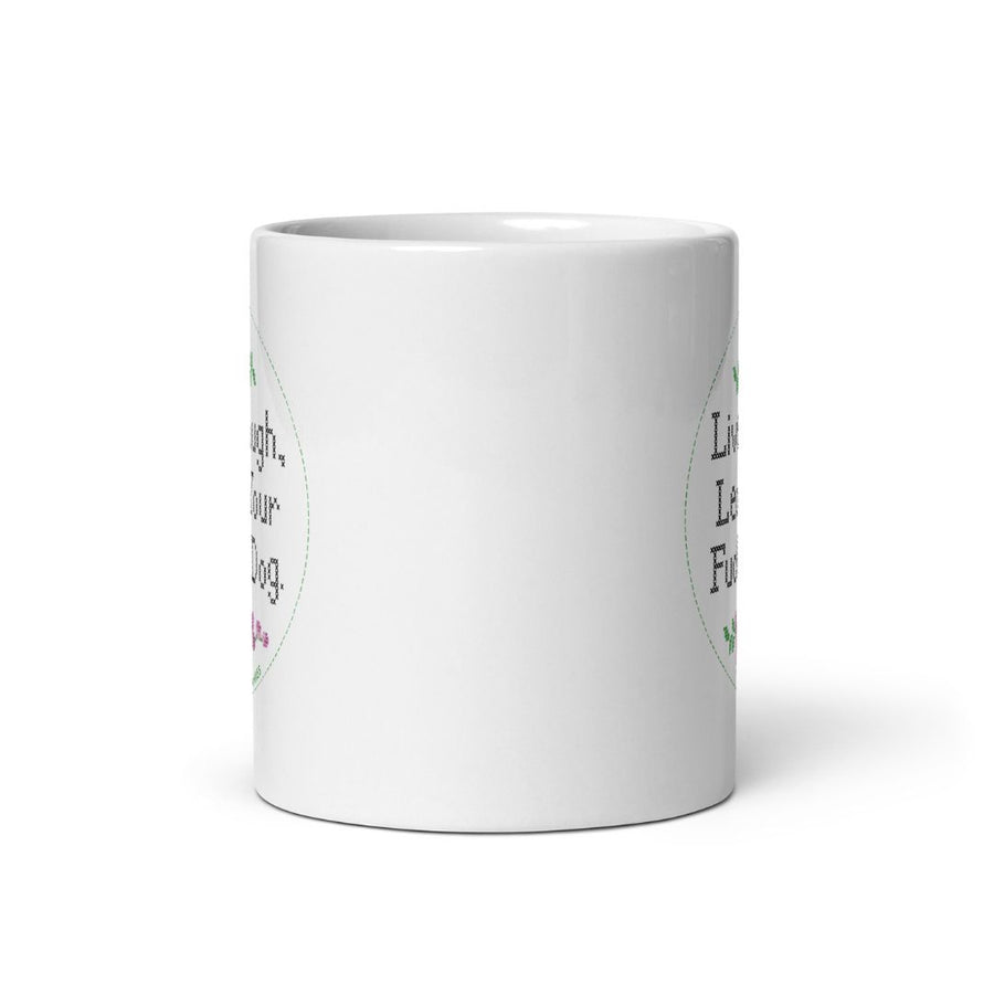 side view of white ceramic mug showing the edge of both sides lettering