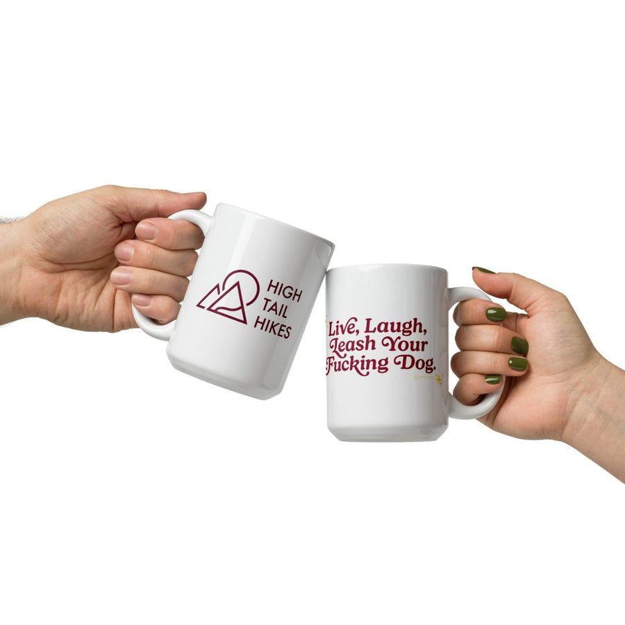 man and woman's hands holding white ceramic mugs with high tail hikes logo and live laugh leash your f dog with red font