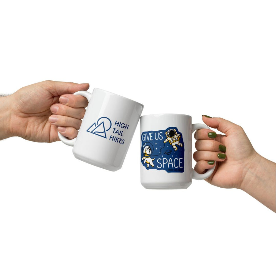 two people holding "give us Pace" mugs 'cheering" each other