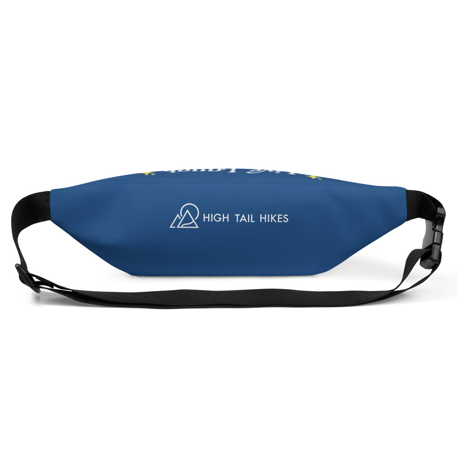 bottom view of blue fanny pack with white high tail hikes logo and black adjustable strap