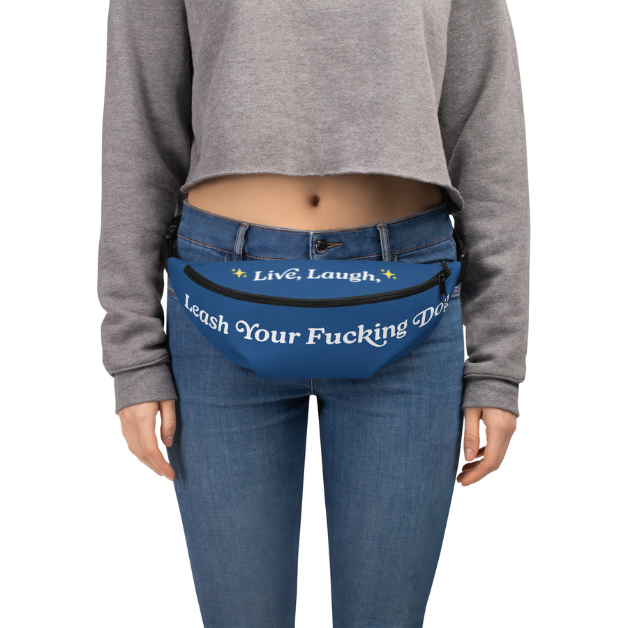 woman wearing blue fanny pack around waist while wearing jeans and short grey sweatshirt