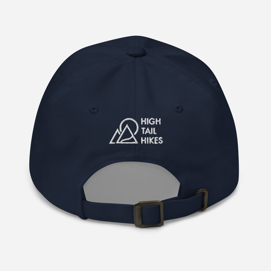 back view of dark blue dad hat with white high tail hikes logo above the adjustable strap