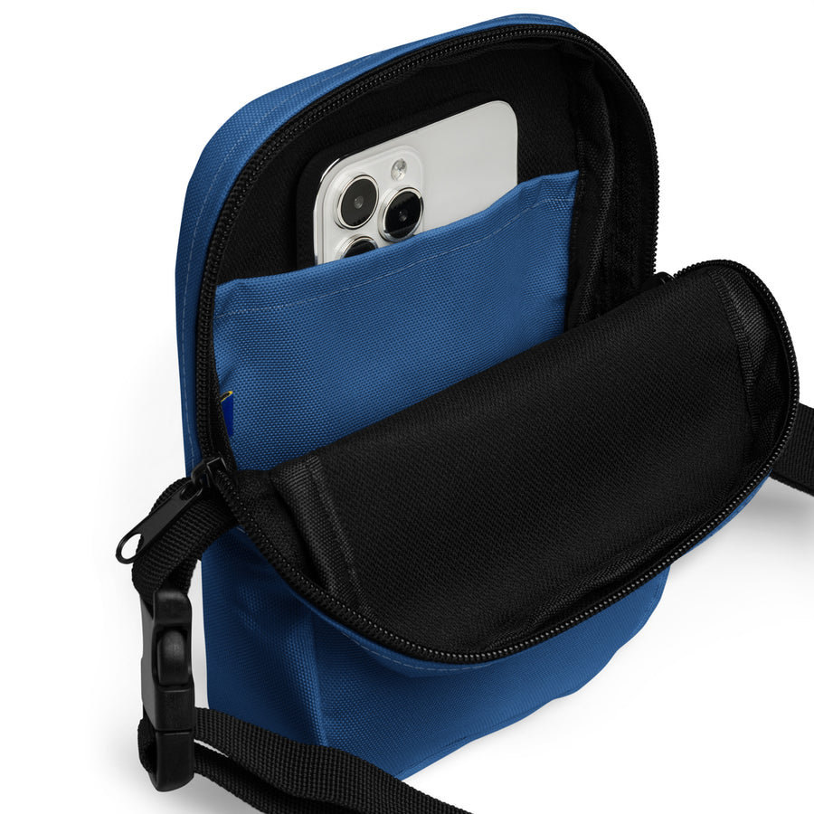 inside view of blue crossbody bag with white cell phone inside