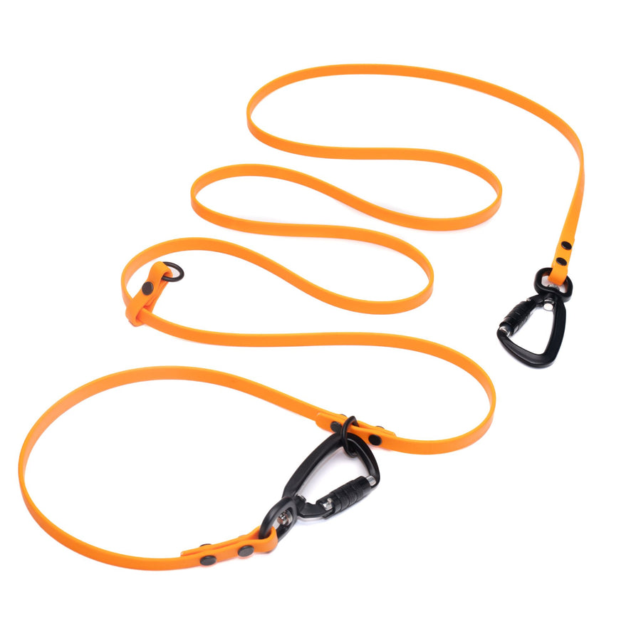 orange hands free waterproof dog leash with black carabiner hardware on white background