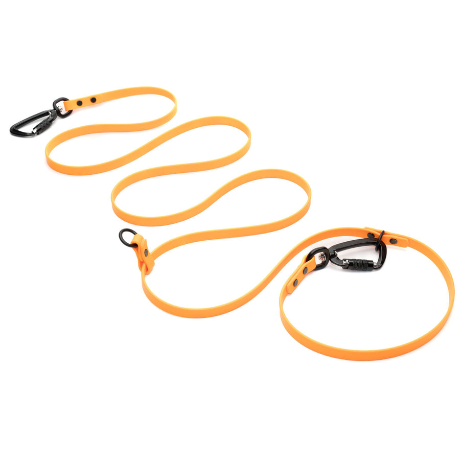orange hands free waterproof dog leash with black carabiner hardware on white background