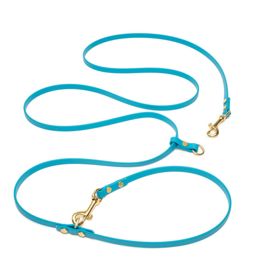 teal waterproof hands free dog leash with brass hardware on white background