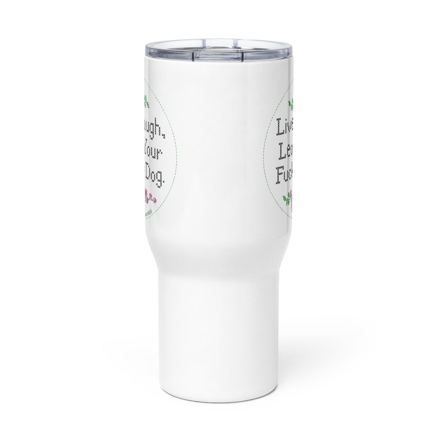 side view of white travel mug with handle, the mug has a pretty cross stitch design print that reads "Live, Laugh, Leash Your F Dog" showing that it is printed on 2 sides
