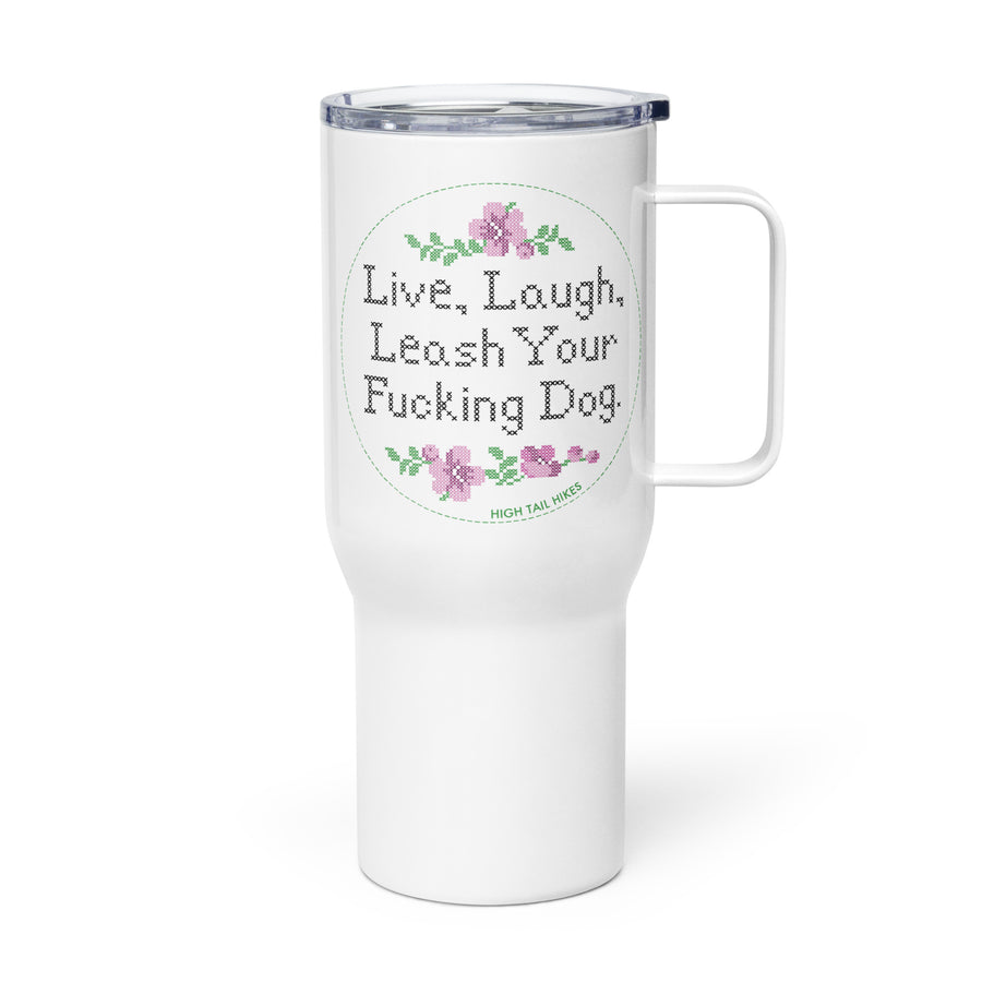 white travel mug with handle, the mug has a pretty cross stitch design print that reads "Live, Laugh, Leash Your F Dog" - handle to the right