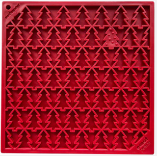 red enrichment lick mat for dogs with small trees like a pine tree