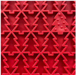 red enrichment lick mat for dogs with small trees close up of the small trees
