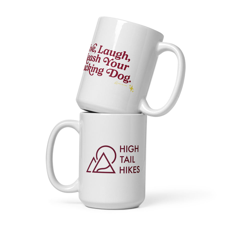 two white 15 oz ceramic mugs stacked on top of each other - the top has red letters that read "Live, Laugh, Leash Your F Dog" while to bottom mug has a red "high Tail hikes" logo