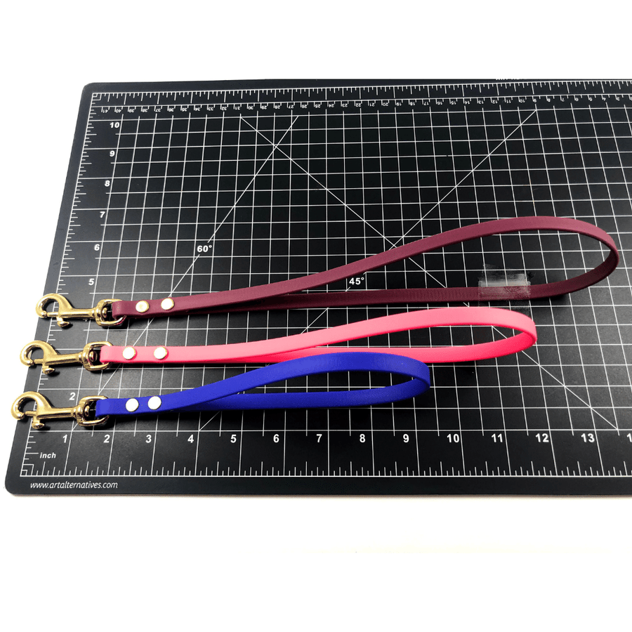 black ruler mat with three biothane traffice handles showing their length 
