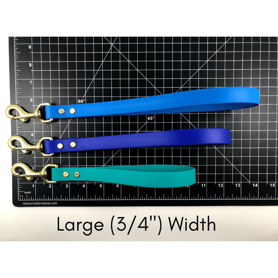black ruler mat with three biothane traffice handles showing their length in the Large 3/4 inch width
