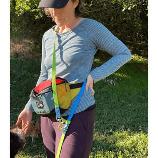 close up of women using the hands free convertible dog leash made of biothane