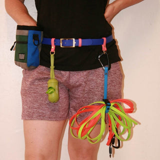 close up of person wearing a biothane utility belt in blueberry with other accessories attached