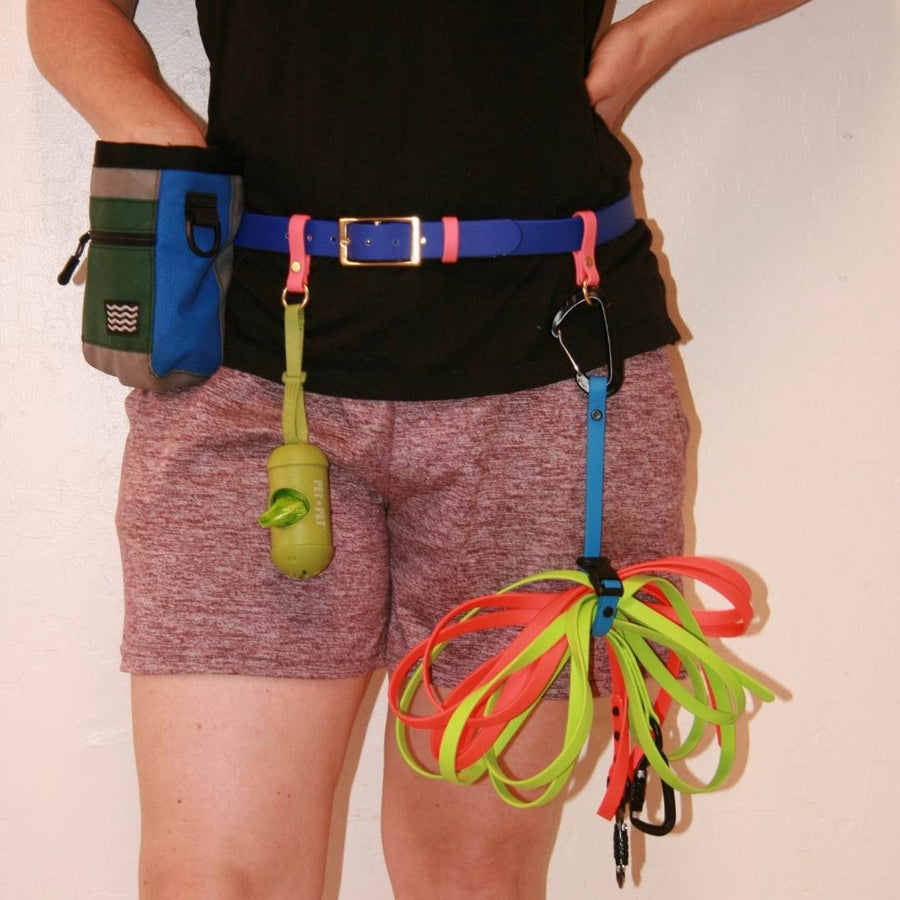 close up of person wearing a biothane utility belt in blueberry with other accessories attached