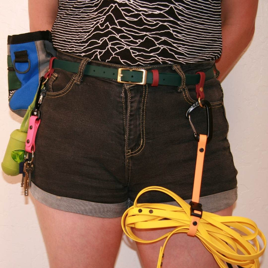 close up of person wearing a biothane utility belt in forest green with other accessories attached