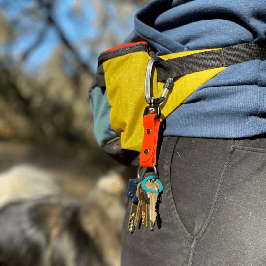 sport biothane keychain with keys attached to persons belt bag