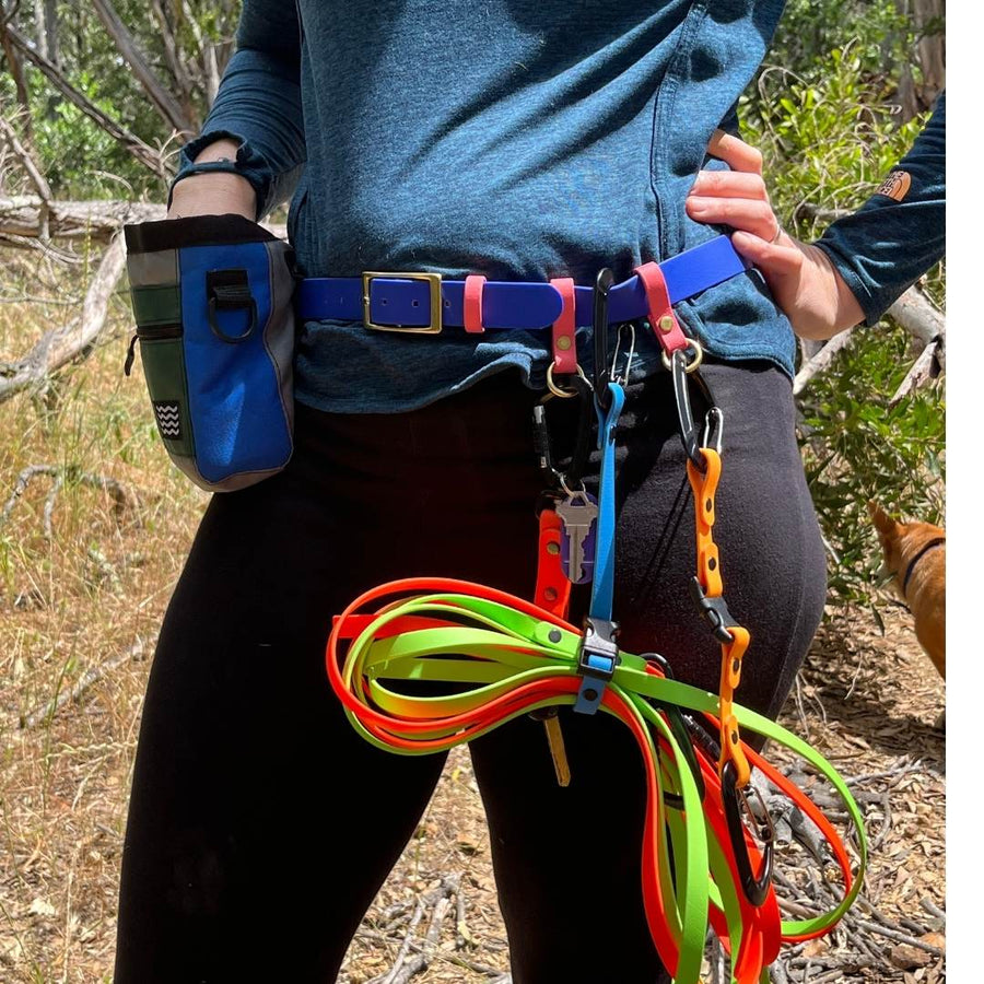 person outside wearing the biothane utility belt with accessories attached