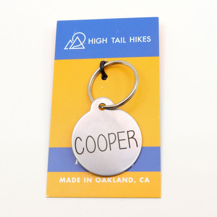 Classic dog ID tag in silver on High Tail Hikes logoed display card