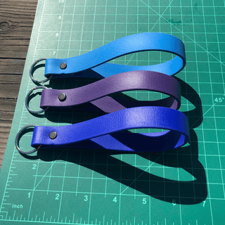 Green Ruler board with three Biothane Key fobs showing their size