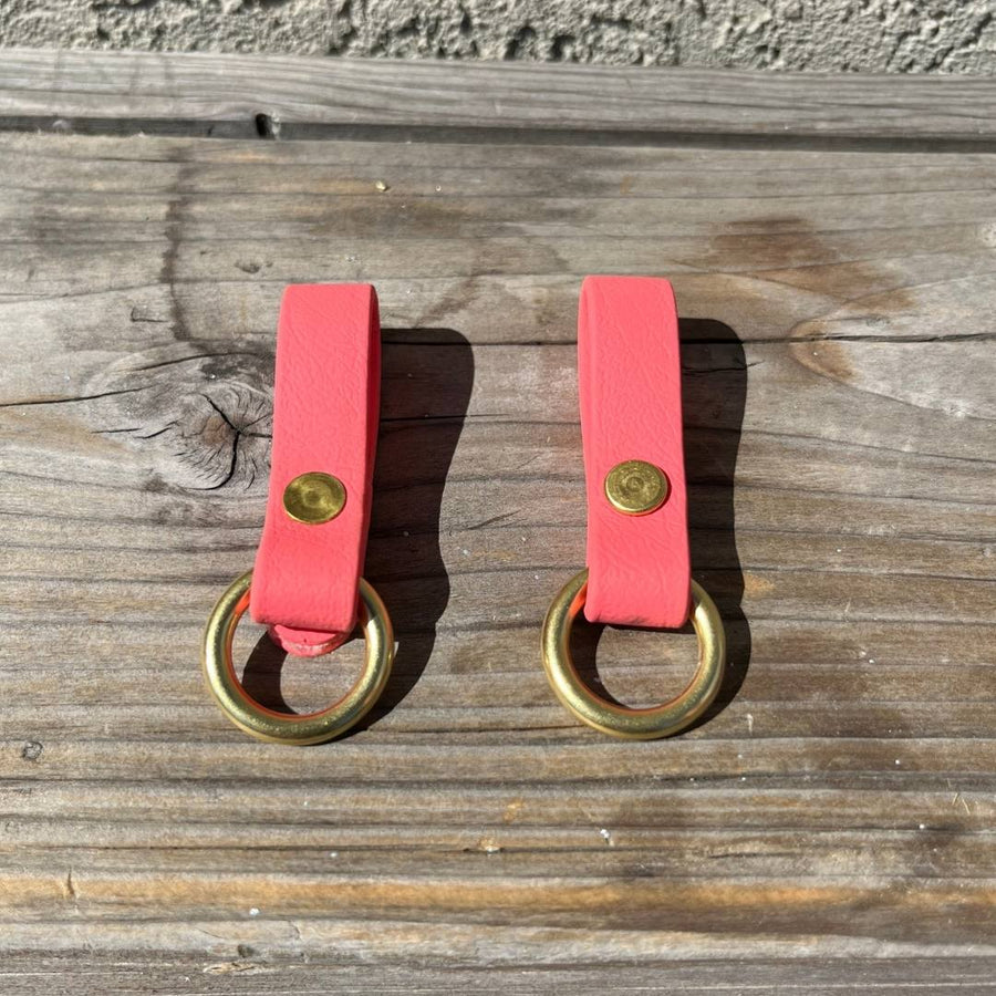 two coral sliding O-rings for biothane utility belt on a bench
