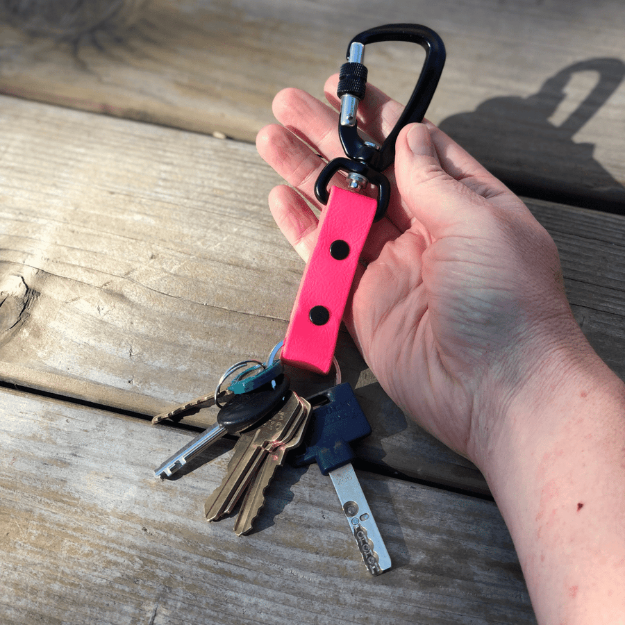 hand holding a sport biothane keychain with keys