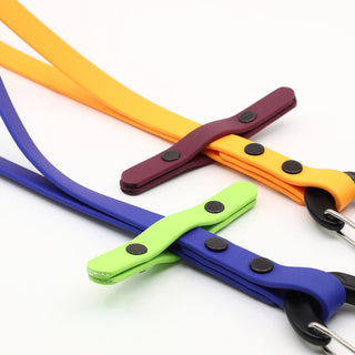close up of two biothane long line keepers - 3 in 1 design - on a white background