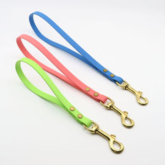 biothane brass traffic handles in sky blue, coral, and green apple on a white background